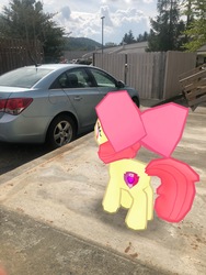 Size: 3024x4032 | Tagged: safe, gameloft, photographer:undeadponysoldier, apple bloom, earth pony, pony, g4, augmented reality, car, female, filly, irl, photo, ponies in real life, solo, vehicle