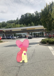 Size: 2856x4032 | Tagged: safe, gameloft, photographer:undeadponysoldier, apple bloom, earth pony, pony, g4, augmented reality, bow, car, cutie mark, female, filly, gamestop, hair bow, irl, parking lot, photo, ponies in real life, solo, the cmc's cutie marks, the rock sports bar & grill