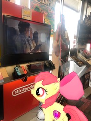 Size: 3024x4032 | Tagged: safe, gameloft, photographer:undeadponysoldier, apple bloom, earth pony, pony, g4, augmented reality, female, filly, gamestop, irl, joycon, nintendo switch, photo, ponies in real life
