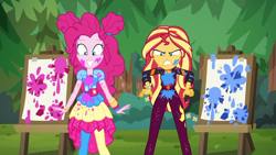 Size: 1920x1080 | Tagged: safe, screencap, pinkie pie, sunset shimmer, equestria girls, equestria girls specials, g4, my little pony equestria girls: better together, my little pony equestria girls: sunset's backstage pass, angry, clothes, cute, diapinkes, duo, duo female, easel, female, geode of empathy, geode of sugar bombs, happy, magical geodes, messy, music festival outfit, outdoors, paint, pantyhose, shrunken pupils, smiling, sunset shimmer is not amused, unamused, varying degrees of amusement