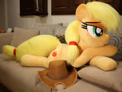 Size: 1024x778 | Tagged: safe, artist:ponimalion, applejack, earth pony, pony, g4, bed, couch, female, hat, irl, lidded eyes, life size, mare, photo, plushie, prone