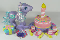 Size: 902x600 | Tagged: safe, photographer:breyer600, razzaroo, pony, g3, birthday cake, box, cake, candle, charm bracelet, comb, cute, female, food, fork, irl, photo, present, toy