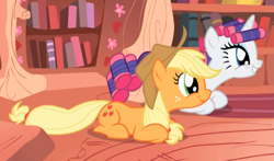 Size: 843x497 | Tagged: safe, screencap, applejack, rarity, earth pony, pony, unicorn, g4, look before you sleep, applejack's hat, cowboy hat, cropped, cute, duo, female, freckles, golden oaks library, hair curlers, hat, jackabetes, mare, prone, raribetes, smiling, wide eyes