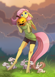 Size: 1897x2676 | Tagged: safe, artist:1an1, fluttershy, bird, pegasus, rabbit, anthro, unguligrade anthro, g4, animal, beautiful, blue eyes, blushing, bunny ears, clothes, cloud, compression shorts, cute, evening, female, floppy ears, grass, halloween, holiday, hoodie, jack-o-lantern, looking at you, pink mane, pink tail, pumpkin, shorts, shyabetes, standing, sweater, wavy mouth, yellow fur