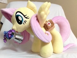 Size: 1185x884 | Tagged: safe, artist:c20710, fluttershy, pegasus, pony, g4, bag, first aid kit, flower, irl, photo, plushie, saddle bag, solo, spread wings, watering can, wings