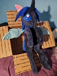 Size: 3024x4032 | Tagged: safe, artist:klplushies, oc, oc only, oc:swift dawn, changeling, bed, bed bug, blue changeling, blue eyes, changeling in a box, changeling oc, cute, irl, photo, plushie, sitting, wings
