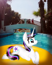 Size: 1000x1250 | Tagged: safe, artist:rxndxm.artist, oc, oc:shooting star, pony, unicorn, female, floaty, horn, irl, lying down, mare, outdoors, photo, ponies in real life, prone, solo, swimming pool, unicorn oc