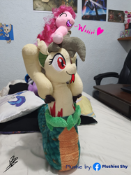 Size: 3024x4032 | Tagged: safe, artist:shappy the lamia, edit, dj pon-3, pinkie pie, vinyl scratch, oc, oc:shappy, earth pony, hybrid, lamia, original species, pony, semi-anthro, g4, arm hooves, bed, bedroom, caption, carrying, female, forked tongue, funny, happy, heart, hooves, image macro, irl, love, mother and child, mother and daughter, photo, pillow, plushie, plushies shy, poster, scales, slit pupils, smiling, snake eyes, snake tail, text