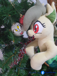 Size: 3024x4032 | Tagged: safe, artist:shappy the lamia, derpy hooves, oc, oc:shappy, hybrid, lamia, original species, semi-anthro, g4, arm hooves, caption, christmas, christmas lights, christmas tree, holiday, image macro, irl, photo, pine tree, plushie, plushies shy, real life background, realistic, scales, slit pupils, snake eyes, solo, text, tree