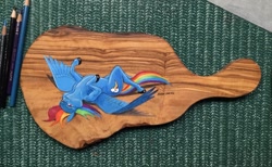 Size: 1140x701 | Tagged: safe, artist:baron engel, rainbow dash, pegasus, pony, g4, backwards cutie mark, cutting board, female, looking at you, lying down, mare, on back, photo, solo, spread wings, traditional art, wings