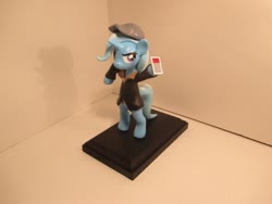Size: 1024x768 | Tagged: source needed, safe, artist:earthenpony, trixie, pony, g4, bipedal, cap, clothes, female, figurine, hat, hoof hold, jacket, mare, solo