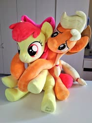 Size: 768x1024 | Tagged: safe, artist:nekokevin, artist:shunnkai, apple bloom, applejack, earth pony, pony, bow, cowboy hat, cute, duo, female, filly, hair bow, hat, hug, irl, lidded eyes, mare, photo, plushie, siblings, sisters, sitting, smiling, underhoof