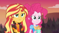 Size: 1920x1080 | Tagged: safe, screencap, pinkie pie, sunset shimmer, equestria girls, equestria girls series, g4, sunset's backstage pass!, spoiler:eqg series (season 2), churros, clothes, crossed arms, duo, duo female, female, food, jacket, music festival outfit, outdoors, raised eyebrow