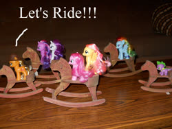 Size: 792x594 | Tagged: safe, applejack, fluttershy, pinkie pie, rainbow dash, rarity, spike, twilight sparkle, pony, g4, brushable, horse riding a horse, mane seven, mane six, merchandise, ponies riding ponies, riding, rocking horse, toy
