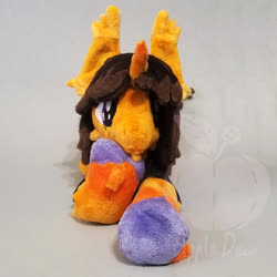 Size: 1000x1000 | Tagged: safe, artist:appledew, classical unicorn, pony, unicorn, cloven hooves, commission, dallon weekes, ear fluff, fetlock tuft, happy, hoof fluff, horn, irl, leonine tail, looking at you, male, photo, plushie, ponified, prone, smiling, solo, stallion, unshorn fetlocks