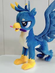 Size: 768x1024 | Tagged: safe, artist:nekokevin, gallus, griffon, g4, irl, lidded eyes, male, marker, mouth hold, open mouth, photo, plushie, smiling, solo, spread wings, talons, teenager, wings