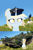 Size: 1080x1628 | Tagged: safe, artist:kotwitz, derpibooru exclusive, edit, oc, oc only, oc:aria taitava, pony, unicorn, beret, blonde, brush, ear fluff, finland, fluffy, hair bun, hat, photo, sitting, smiling, solo, stridsvagn 103, swedish, tank (vehicle), vandalism, world of tanks