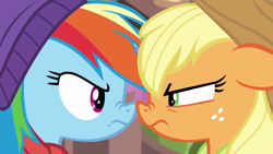 Size: 1280x720 | Tagged: safe, screencap, applejack, rainbow dash, earth pony, pegasus, pony, g4, triple pony dare ya, applejack is not amused, applejack's hat, competitive, cowboy hat, determined, duo, female, freckles, frown, glare, green eyes, looking at each other, magenta eyes, mare, multicolored mane, narrowed eyes, nose wrinkle, noseboop, rainbow dash is not amused, rivalry, stetson, unamused, winter cap