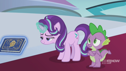 Size: 1280x720 | Tagged: safe, screencap, spike, starlight glimmer, dragon, pony, unicorn, g4, memories and more, my little pony: friendship is forever, 9now, book, crossed arms, duo, levitation, magic, magic aura, mid-blink screencap, scrapbook, telekinesis, winged spike, wings
