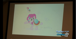 Size: 1366x704 | Tagged: safe, artist:cooltomorrowkid, artist:ellybethe, pinkie pie, earth pony, pony, bronycon, journey of the spark, g4, alternate hairstyle, clothes, concept art, convention, dress, everfree network, female, mare, photo, raised hoof, raised leg, signature, smiling