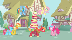 Size: 2000x1125 | Tagged: safe, screencap, big macintosh, carrot cake, cup cake, fluttershy, pinkie pie, rainbow dash, earth pony, pegasus, pony, g4, mmmystery on the friendship express, balancing, cake, female, flying, food, hard hat, male, mare, marzipan mascarpone meringue madness, pegassistance, ponyville, rope, stallion