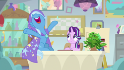 Size: 1920x1080 | Tagged: safe, screencap, phyllis, starlight glimmer, trixie, pony, unicorn, a horse shoe-in, cape, clothes, desk, duo, female, hat, hooves in air, mare, nose in the air, open mouth, philodendron, plant, potted plant, spreading, trixie's cape, trixie's hat