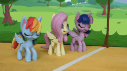 Size: 800x450 | Tagged: safe, screencap, fluttershy, rainbow dash, twilight sparkle, alicorn, pegasus, pony, g4.5, my little pony: stop motion short, the great race (short), animated, eyes closed, female, gif, grass, smiling, starting line, stop motion, tree, twilight sparkle (alicorn), wings