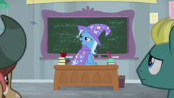 Size: 1920x1080 | Tagged: safe, screencap, trixie, yona, pony, unicorn, yak, a horse shoe-in, apple, cape, clothes, desk, female, food, hat, lidded eyes, mare, solo focus, trixie's cape, trixie's hat