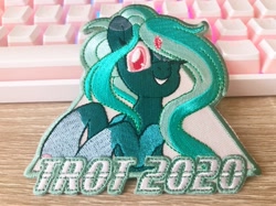 Size: 1277x957 | Tagged: safe, artist:pearlyiridescence, oc, oc only, oc:proxy server, pony, trotcon, convention, convention mascots, craft, cute, embroidery, female, irl, keyboard, mascot, one eye closed, photo, smiling, solo, wink, winking at you