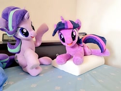 Size: 1024x768 | Tagged: safe, artist:nekokevin, starlight glimmer, twilight sparkle, pony, unicorn, series:nekokevin's glimmy, g4, alarm clock, bed, clock, duo, female, irl, looking at you, lying down, mare, open mouth, photo, pillow, plushie, raised hoof, sitting, smiling, underhoof, unicorn twilight