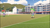 Size: 2208x1242 | Tagged: safe, artist:undeadponysoldier, rainbow dash, spike, human, g4, building, competitive, female, football, gacha life, goal, goalie, humanized, male, ponytail, soccer field, soccer goalpost, sports