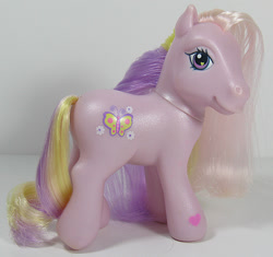 Size: 638x600 | Tagged: safe, photographer:breyer600, fluttershy (g3), butterfly, earth pony, pony, g3, cute, cutie mark, female, flower, heart eyes, irl, looking at you, mare, photo, smiling, solo, toy, wingding eyes