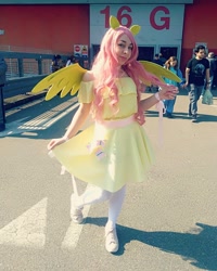 Size: 1080x1350 | Tagged: safe, fluttershy, human, g4, clothes, cosplay, costume, cutie mark, cutie mark on clothes, dress, female, irl, irl human, photo, wings