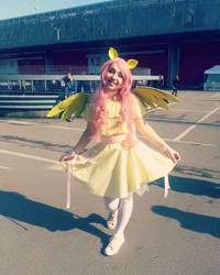 Size: 1080x1350 | Tagged: safe, fluttershy, human, g4, clothes, cosplay, costume, curtsey, cutie mark, cutie mark on clothes, dress, female, irl, irl human, photo, shoes, wings
