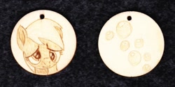 Size: 1024x513 | Tagged: safe, artist:malte279, derpy hooves, pegasus, pony, g4, craft, cutie mark, female, jewelry, pendant, pyrography, traditional art, wood