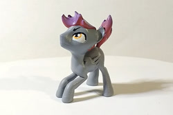 Size: 900x600 | Tagged: safe, artist:mraagh, oc, oc only, oc:bordy, pegasus, pony, 3d, 3d print, eyebrows, eyes open, figurine, gray coat, looking up, male, multicolored hair, photo, shadow, simple background, solo, squatting, stallion, yellow eyes