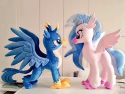 Size: 1024x768 | Tagged: safe, artist:nekokevin, gallus, silverstream, classical hippogriff, griffon, hippogriff, g4, duo, female, irl, lidded eyes, looking at each other, male, photo, plushie, size difference, smiling, spread wings, wings