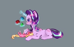 Size: 1030x664 | Tagged: safe, artist:lunar_cosmos, luster dawn, starlight glimmer, pony, unicorn, g4, blocks, cute, daaaaaaaaaaaw, female, filly, foal, glimmerbetes, glowing horn, gray background, horn, levitation, luster dawn is starlight's and sunburst's daughter, lusterbetes, lying down, magic, mama starlight, mother and child, mother and daughter, offspring, parent:starlight glimmer, parent:sunburst, parents:starburst, simple background, smiling, telekinesis