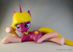 Size: 1024x725 | Tagged: safe, artist:mraagh, oc, oc only, oc:autumn dawn, pony, unicorn, 3d, 3d print, anatomically incorrect, big eyelashes, blue eyes, clothes, cute, cutie mark, eyelashes, eyes open, female, figure, figurine, gift art, gray coat, hair in mouth, happy, incorrect leg anatomy, irl, looking at you, lying down, mare, painted, photo, silly, simple background, socks, solo, statue, teeth, yellow mane