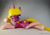 Size: 1024x725 | Tagged: safe, artist:mraagh, oc, oc only, oc:autumn dawn, pony, unicorn, 3d, 3d print, anatomically incorrect, big eyelashes, blue eyes, clothes, cute, cutie mark, eyelashes, eyes open, female, figure, figurine, gift art, gray coat, hair in mouth, happy, incorrect leg anatomy, irl, looking at you, lying down, mare, painted, photo, silly, simple background, socks, solo, statue, teeth, yellow mane