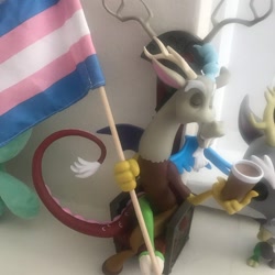 Size: 1080x1080 | Tagged: safe, discord, draconequus, g4, chair, cup, duo, eyes closed, flag, horns, irl, male, photo, pride, pride flag, sitting, toy, transgender pride flag, wings