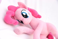 Size: 4096x2731 | Tagged: safe, artist:shunnkai, pinkie pie, earth pony, pony, g4, female, irl, looking at you, lying down, mare, photo, plushie, smiling, solo, underhoof