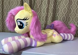 Size: 1595x1144 | Tagged: safe, artist:qtpony, fluttershy, pony, g4, bow, clothes, irl, lying down, photo, plushie, prone, socks, solo, striped socks, tail bow