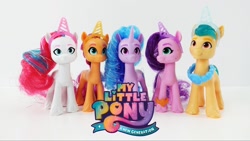 Size: 1280x720 | Tagged: safe, hitch trailblazer, izzy moonbow, pipp petals, sunny starscout, zipp storm, earth pony, pegasus, pony, unicorn, g5, my little pony: a new generation, mane five, simple background, toy, white background