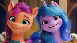 Size: 1436x801 | Tagged: safe, edit, screencap, izzy moonbow, sunny starscout, earth pony, pony, unicorn, g5, my little pony: a new generation, spoiler:my little pony: a new generation, cropped, cute, female, izzybetes, looking at you, mare, smiling, sunnybetes
