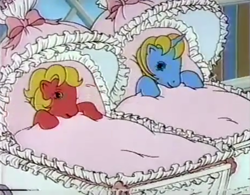 Size: 1963x1534 | Tagged: safe, screencap, baby ribbon, baby shady, earth pony, pony, unicorn, g1, 1980's, 1986, 80s, advertisement, awake, baby, baby buggy, baby pony, baby ribbondorable, baby shadybetes, beddy bye eye baby ponies, beddy bye eyes, blanket, commercial, cute, duo, female, filly, looking at each other, lullabye nursery, nursery, smiling, smiling at each other, stroller, wake up