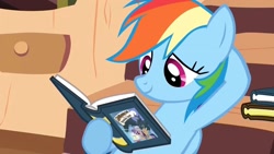 Size: 1280x720 | Tagged: safe, editor:rarity vrymer collective, screencap, rainbow dash, pegasus, pony, a friend in deed, g4, book, daring do book, female, folded wings, golden oaks library, mare, multicolored hair, multicolored mane, reading, reading rainbow, smiling, solo