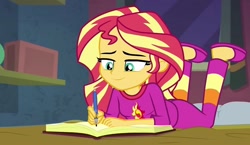 Size: 1243x720 | Tagged: safe, screencap, sunset shimmer, equestria girls, equestria girls series, forgotten friendship, g4, bed, book, clothes, female, lying down, pajamas, slippers, smiling, solo, writing