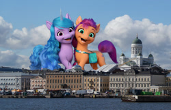 Size: 1595x1025 | Tagged: safe, artist:theotterpony, izzy moonbow, sunny starscout, earth pony, pony, unicorn, g5, my little pony: a new generation, female, finland, giant pony, giantess, helsinki, highrise ponies, irl, macro, mare, photo, ponies in real life, story included
