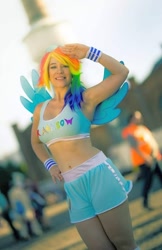 Size: 698x1080 | Tagged: safe, rainbow dash, human, g4, belly button, clothes, cosplay, costume, irl, irl human, photo, salute